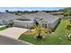 Attractive home with a well-manicured lawn, three-car garage, and inviting front yard landscaping at 5220 Horsford Path, The Villages, FL 32163