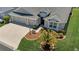 Well-maintained home with a spacious driveway, attractive landscaping, and a welcoming entrance at 5220 Horsford Path, The Villages, FL 32163