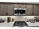 Modern kitchen features stainless steel appliances, including a gas range and microwave at 5220 Horsford Path, The Villages, FL 32163