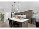 Modern kitchen featuring a large island with bar stools, countertops, and sleek appliances at 5220 Horsford Path, The Villages, FL 32163