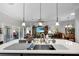 Kitchen island with tile floors and open view into the living room at 5220 Horsford Path, The Villages, FL 32163