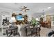 Cozy living room featuring a built-in entertainment center, sofas, and dining area at 5220 Horsford Path, The Villages, FL 32163