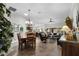 Open-concept living space featuring wood floors, a dining area, and a view of the backyard at 5220 Horsford Path, The Villages, FL 32163