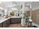 An expansive main bathroom with double sinks, quartz countertop, and a separate shower at 5220 Horsford Path, The Villages, FL 32163