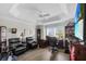 Spacious office area with ceiling fan, built in shelves, dark wood furniture and tile floors at 5220 Horsford Path, The Villages, FL 32163