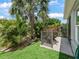 Landscaped backyard featuring lush greenery, a paved patio, and serene atmosphere at 575 Wheelock St, The Villages, FL 32163