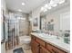 Bathroom featuring a granite countertop vanity and shower with sea-themed decor at 575 Wheelock St, The Villages, FL 32163
