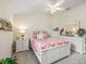 Neutral bedroom featuring a full bed with matching white dresser and nightstand at 575 Wheelock St, The Villages, FL 32163