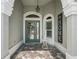 Elegant entryway featuring a decorative door, tiled flooring, and stylish decor elements with ample natural light at 575 Wheelock St, The Villages, FL 32163