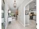 Open foyer featuring tile floors, neutral decor, and views into the living area, dining room, and kitchen at 575 Wheelock St, The Villages, FL 32163