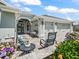 Inviting front porch with outdoor seating, decorative plants, and a beautiful entrance leading to the home at 575 Wheelock St, The Villages, FL 32163