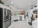 Bright kitchen features stainless steel appliances, white cabinetry, and a view into the breakfast nook at 575 Wheelock St, The Villages, FL 32163