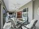 Spacious lanai with comfortable seating, ceiling fans, and views into the dining area at 575 Wheelock St, The Villages, FL 32163