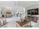 Spacious living room with an open floor plan, a ceiling fan, and a view into the kitchen and breakfast nook at 575 Wheelock St, The Villages, FL 32163