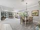 Expansive living area featuring dining and seating spaces, bright lighting, and a neutral color palette at 575 Wheelock St, The Villages, FL 32163