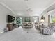 Inviting living room with a large TV, comfortable seating, and natural light from the windows and sliding doors at 575 Wheelock St, The Villages, FL 32163