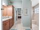 Spacious bathroom featuring a granite vanity, tiled floors, and step-in shower at 575 Wheelock St, The Villages, FL 32163