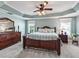 Charming bedroom with wooden bed frame, large dresser and decorative pillows at 575 Wheelock St, The Villages, FL 32163