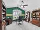 Inviting home office with ceiling fan, built-in bookshelves, and work space at 575 Wheelock St, The Villages, FL 32163