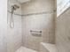 Attractive tile shower with shower head, grab bar, and mosaic tile trim at 575 Wheelock St, The Villages, FL 32163