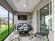 Relaxing sunroom with large windows, comfortable seating, and a decorative area rug at 575 Wheelock St, The Villages, FL 32163
