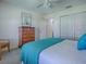 Comfortable bedroom with neutral colors, a dresser, and access to an ensuite bathroom at 633 Jameston Ave, The Villages, FL 32162