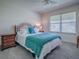 Cozy bedroom featuring plush carpeting, a ceiling fan, and a bright window with blinds at 633 Jameston Ave, The Villages, FL 32162