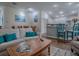 Bright and airy living space featuring a comfortable sofa, dining area, and a kitchen island with bar seating at 633 Jameston Ave, The Villages, FL 32162