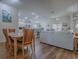 Open-concept living space with wood floors, dining area, living room, and bright kitchen with stainless steel appliances at 633 Jameston Ave, The Villages, FL 32162