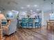 Open living space featuring a breakfast bar with seating, kitchen, dining area, and a cozy living room setup at 633 Jameston Ave, The Villages, FL 32162