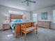 Spacious bedroom features a king bed with decorative pillows, ceiling fan and sunny windows at 633 Jameston Ave, The Villages, FL 32162