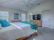 Bright bedroom with a large bed, grey carpet and ensuite bathroom at 633 Jameston Ave, The Villages, FL 32162