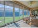 Spacious sunroom offering panoramic views of the landscaped backyard at 633 Jameston Ave, The Villages, FL 32162