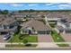 Aerial view of a single Gathering home with a well-manicured lawn and a three-car garage at 677 Brooks Field Dr, Winter Garden, FL 34787