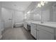 Luxurious bathroom with a soaking tub, walk-in shower, and dual sink vanity with white cabinets at 677 Brooks Field Dr, Winter Garden, FL 34787