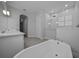 Modern bathroom with a soaking tub, walk-in shower, and dual sink vanity with quartz countertops at 677 Brooks Field Dr, Winter Garden, FL 34787