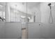 Modern bathroom showcasing a glass-enclosed shower with subway tile surround and elegant fixtures at 677 Brooks Field Dr, Winter Garden, FL 34787