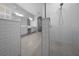 Stylish bathroom features a walk-in shower with subway tile, a double vanity, and tile floors at 677 Brooks Field Dr, Winter Garden, FL 34787