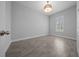 Clean and bright bedroom with wood-look tile floors, white trim, a ceiling light and a window with shutters at 677 Brooks Field Dr, Winter Garden, FL 34787