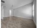 Spacious bedroom featuring wood-style tile flooring, ceiling fan, and natural light from the window at 677 Brooks Field Dr, Winter Garden, FL 34787