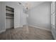 A large room with wood-look ceramic floors, a large closet, and a stylish chandelier at 677 Brooks Field Dr, Winter Garden, FL 34787