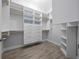 Custom closet offers built-in shelving, drawers, and hanging rods for optimal organization at 677 Brooks Field Dr, Winter Garden, FL 34787