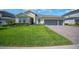 Attractive single-story home with a well-maintained lawn, complementary landscaping, and a spacious three-car garage at 677 Brooks Field Dr, Winter Garden, FL 34787