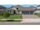 Charming single-Gathering home with lush lawn, manicured landscaping, and a two-car garage at 677 Brooks Field Dr, Winter Garden, FL 34787