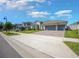 Inviting single-Gathering home featuring a well-manicured lawn and a spacious two-car garage at 677 Brooks Field Dr, Winter Garden, FL 34787