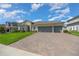 Alluring single-story residence showcasing manicured lawns, beautiful landscaping, and an attached three-car garage at 677 Brooks Field Dr, Winter Garden, FL 34787