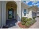 Welcoming front entrance with a glass-paneled door, stylish lighting, and manicured shrubs at 677 Brooks Field Dr, Winter Garden, FL 34787