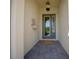 Cozy entryway features a modern door with glass panes, stylish sconce lighting, and brick paving at 677 Brooks Field Dr, Winter Garden, FL 34787