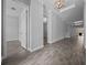 Hallway featuring wood-look tile flooring, crown molding and an arched niche, leading to other rooms in the home at 677 Brooks Field Dr, Winter Garden, FL 34787