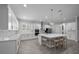 Modern kitchen boasts white cabinetry, quartz countertops and stainless steel appliances at 677 Brooks Field Dr, Winter Garden, FL 34787